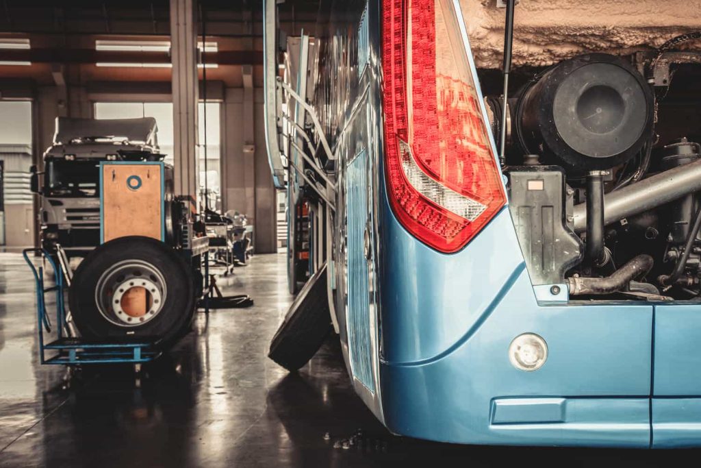 bus and truck waiting for service in the garage, vintage photo and film style