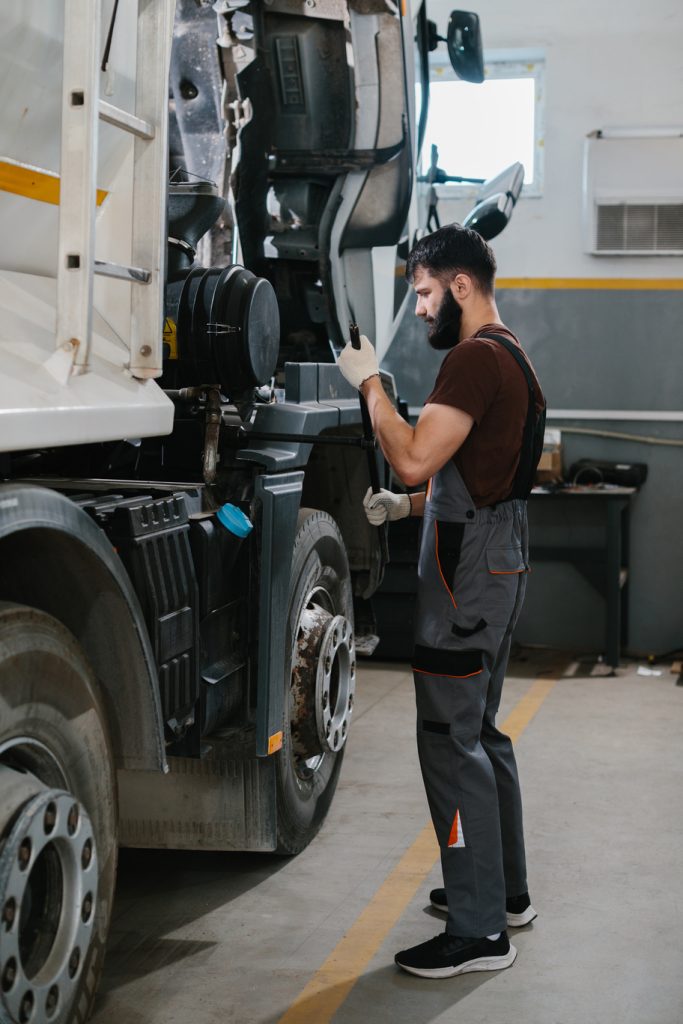 mechanic repairing truck engine in garage workshop 2026 03 24 05 15 32 utc